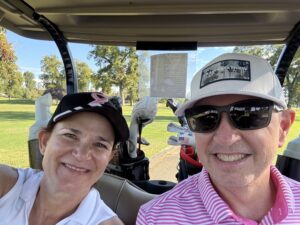 Jennifer Henry and Husband, playing golf.